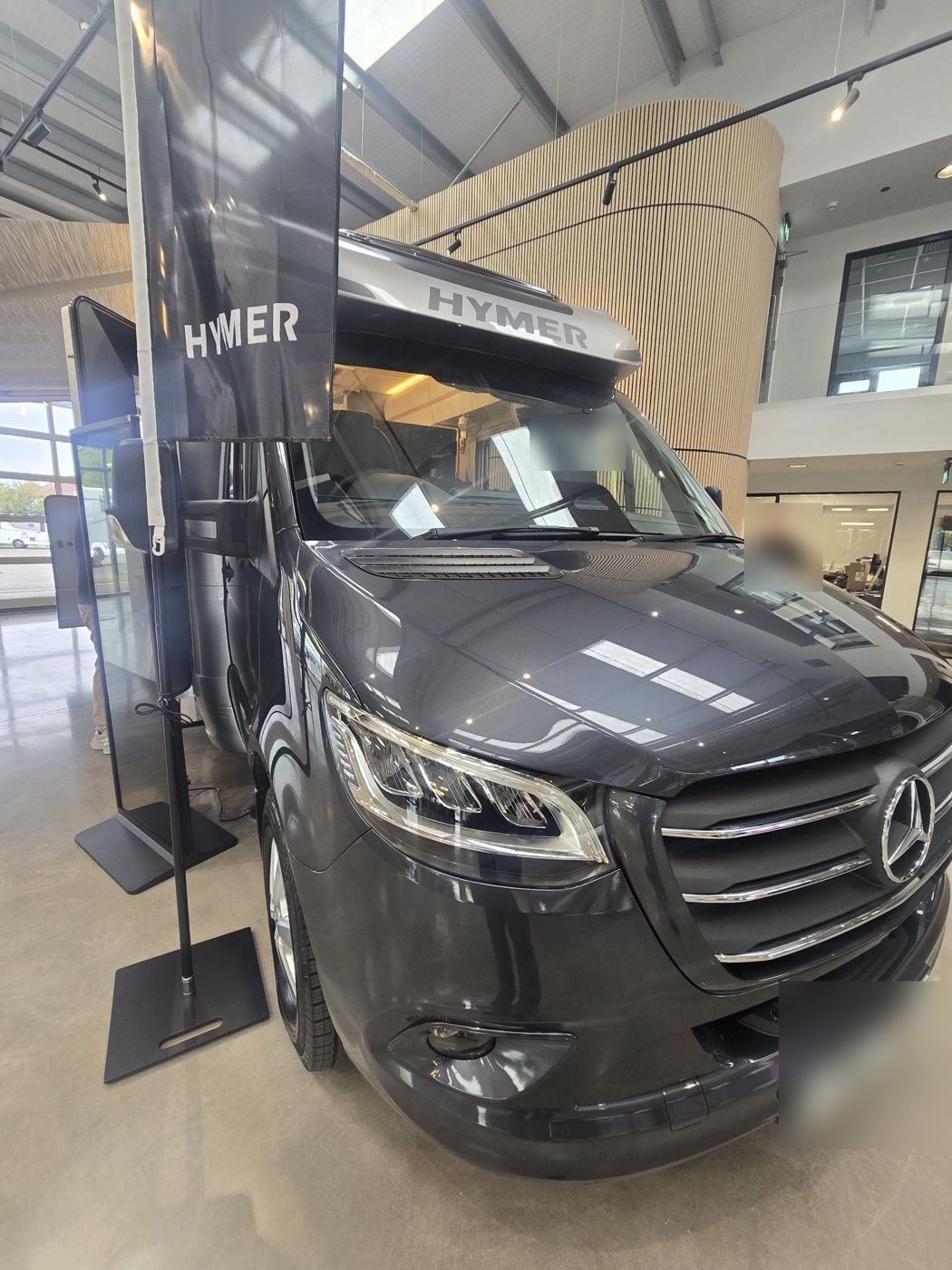 Grey motorhome on display in a showroom